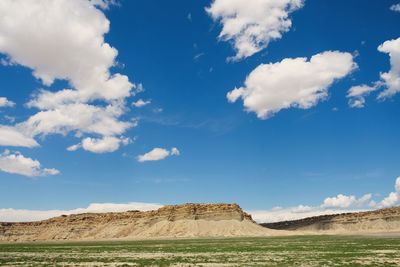 Scenic view of land against cloudy sky