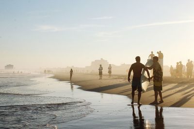 People on water against sky