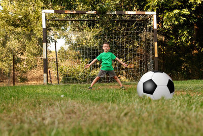 Boy playing soccer on field