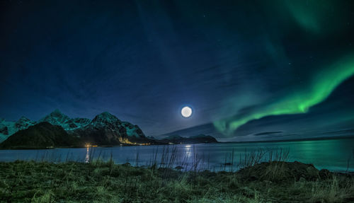 Scenic view of lake against sky at night