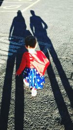 High angle view of siblings walking on floor