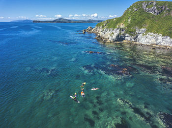 High angle view of people on sea shore against sky