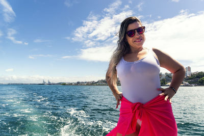 A woman on top of a boat against the sea in the background. salvador, bahia, brazil.