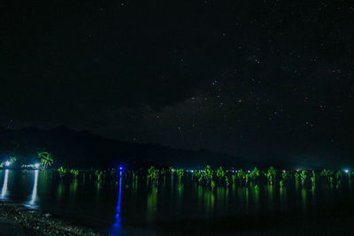 Scenic view of lake against sky at night