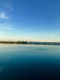 Scenic view of lake against blue sky