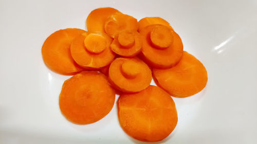 High angle view of orange fruit against white background