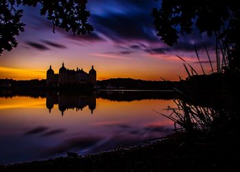 Scenic view of lake against orange sky