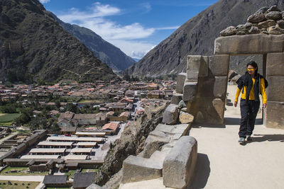 Woman exploring inca ruins above ollantaytambo, peru