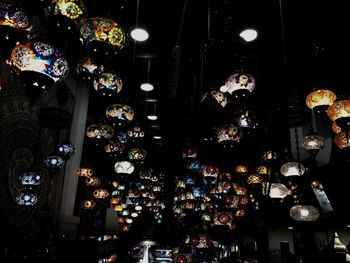 Low angle view of illuminated lanterns at night