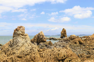 Rocks on beach against sky