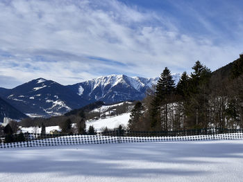 Scenic view of snow covered mountains against sky