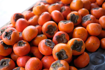 Close-up of persimmons for sale at market stall