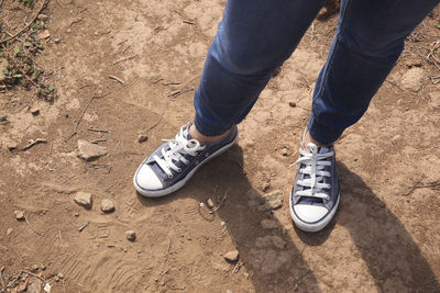 Low section of man standing on ground