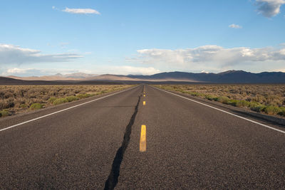 Road passing through landscape against sky