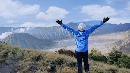 Rear view of woman standing on mountain