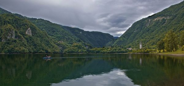 Scenic view of lake against cloudy sky