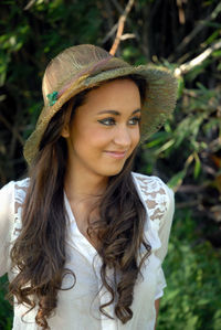 Portrait of smiling young woman wearing hat