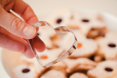 Close up view of the pastry cutter against a bowl of cookies