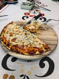 High angle view of pizza served on table