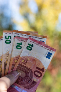 Cropped hand holding paper currency