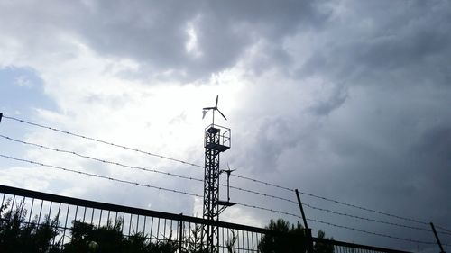 Low angle view of windmill against sky