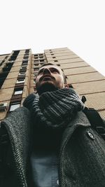 Low angle view of man on office building against sky