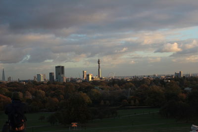 View of cityscape against cloudy sky