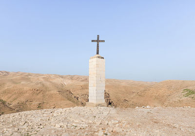 Low angle view of cross against sky