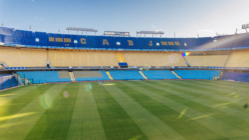 View of soccer field against clear blue sky