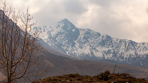 Scenic view of snowcapped mountains against sky