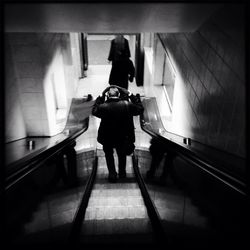 Woman walking on escalator