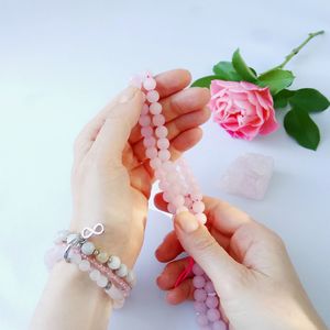 Cropped hands of woman holding necklace