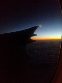 Cropped image of airplane flying over sea