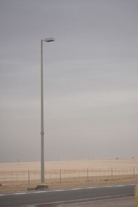 Street light by road against sky