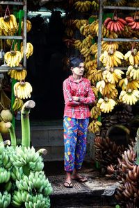 Rear view of woman standing at market stall