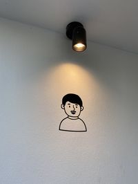 Low angle view of illuminated light bulb hanging on ceiling
