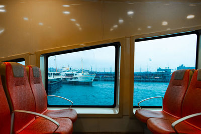 View of sea and a shipagainst sea seen through a ferry's window