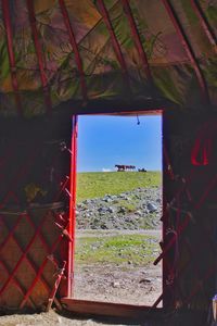 Scenic view of field seen through window