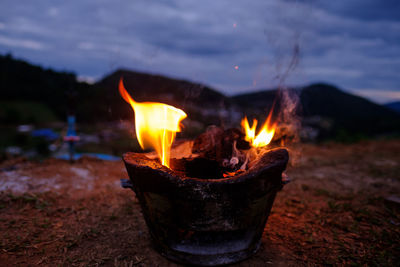 Close-up of fire against sky at night