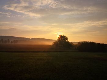 Scenic view of field against sky during sunset