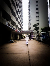 Rear view of woman walking on city street