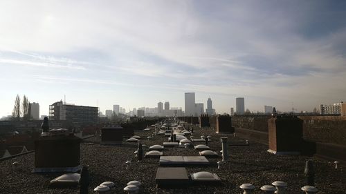 Chimneys on building terrace against sky