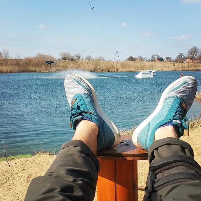 low section, person, personal perspective, shoe, water, lifestyles, blue, human foot, leisure activity, footwear, lake, part of, standing, jeans, sky, men, legs crossed at ankle