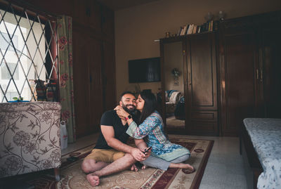 Young couple sitting on sofa at home