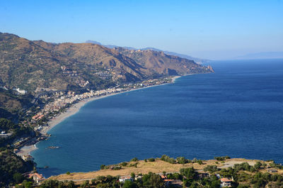 Scenic view of sea and mountains against sky