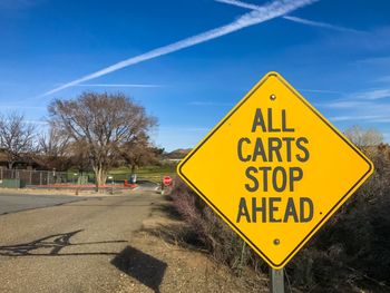 Road sign against blue sky