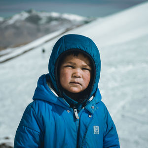 Portrait of young man skiing on snow