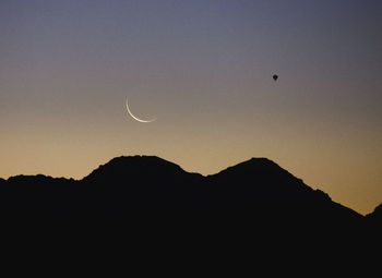 Low angle view of silhouette mountains against sky at sunset