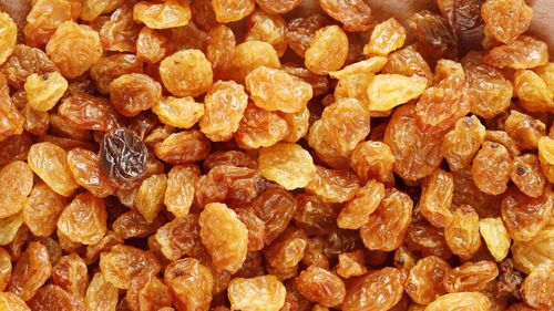 Golden raisin food background, top view. food texture with sweet raisin