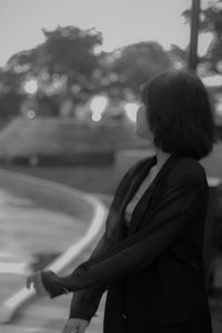 Side view of woman looking at city